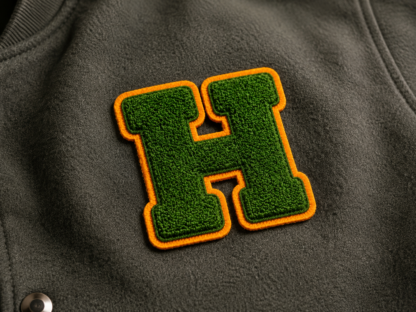 Chenille patch detail on varsity-style apparel
